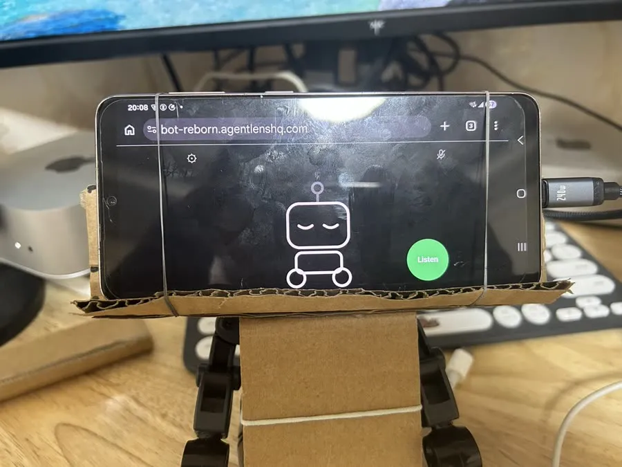 The phone held on the headless robot by the cardboard mount and rubber bands